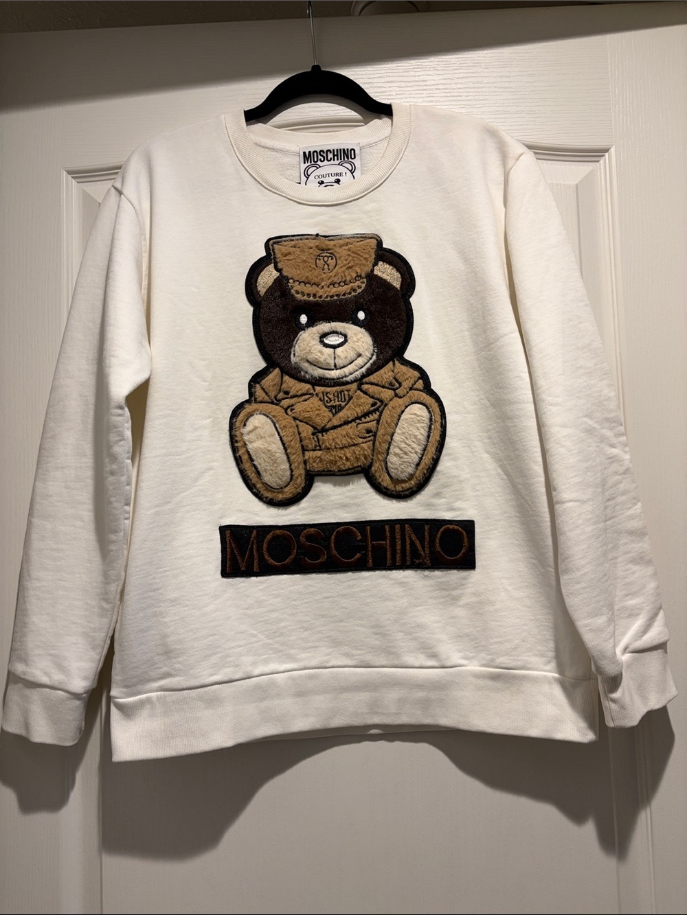 Moschino White Sweatshirt with Brown Teddy Patch pit to pit 24” shou. To hem 26”